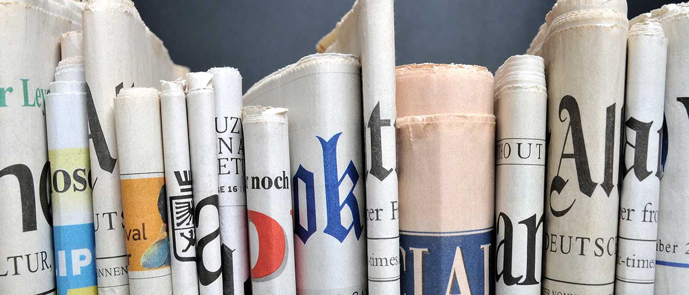 Spine view of newspapers.